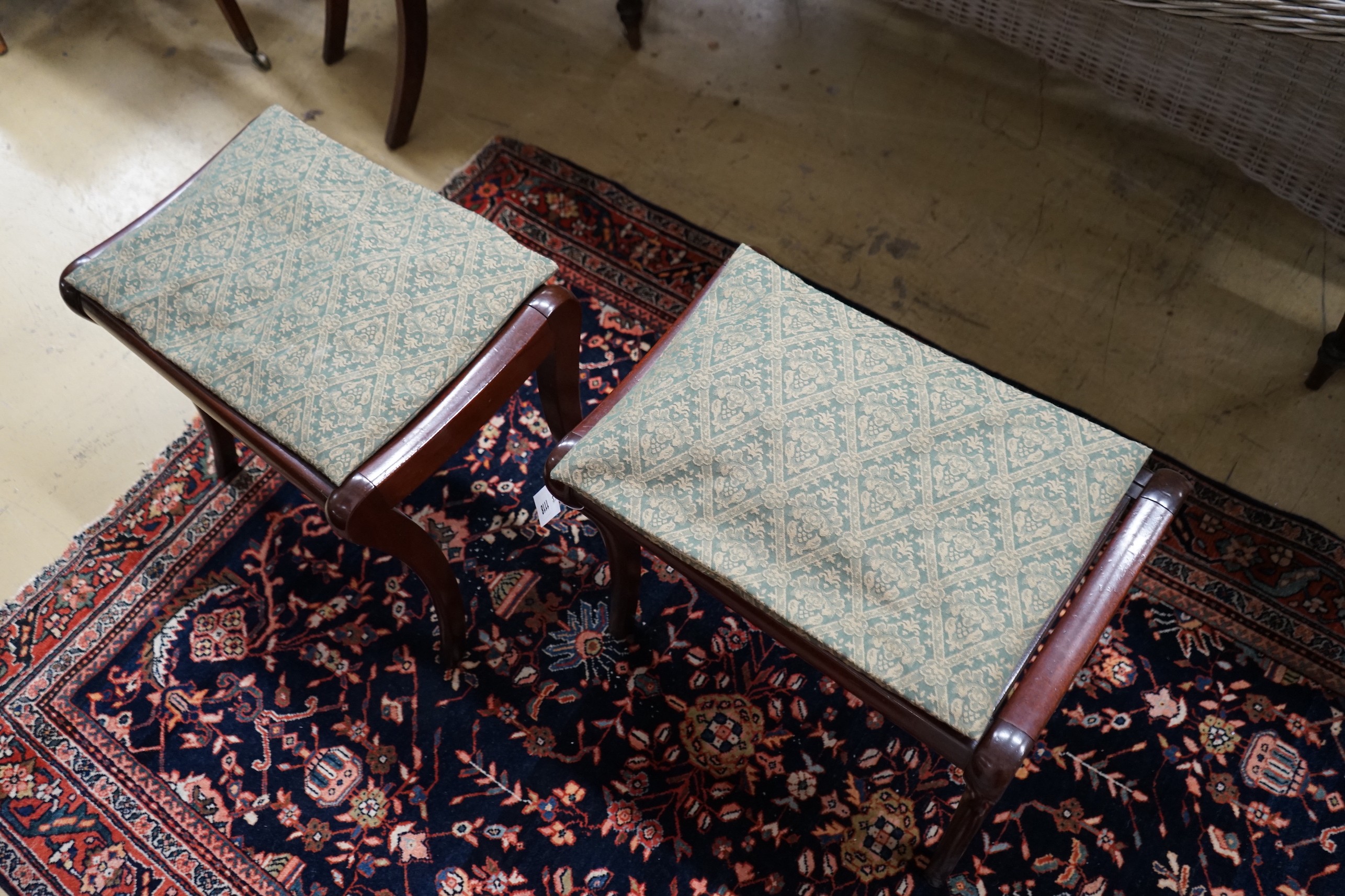 A pair of Regency style cane seat stools